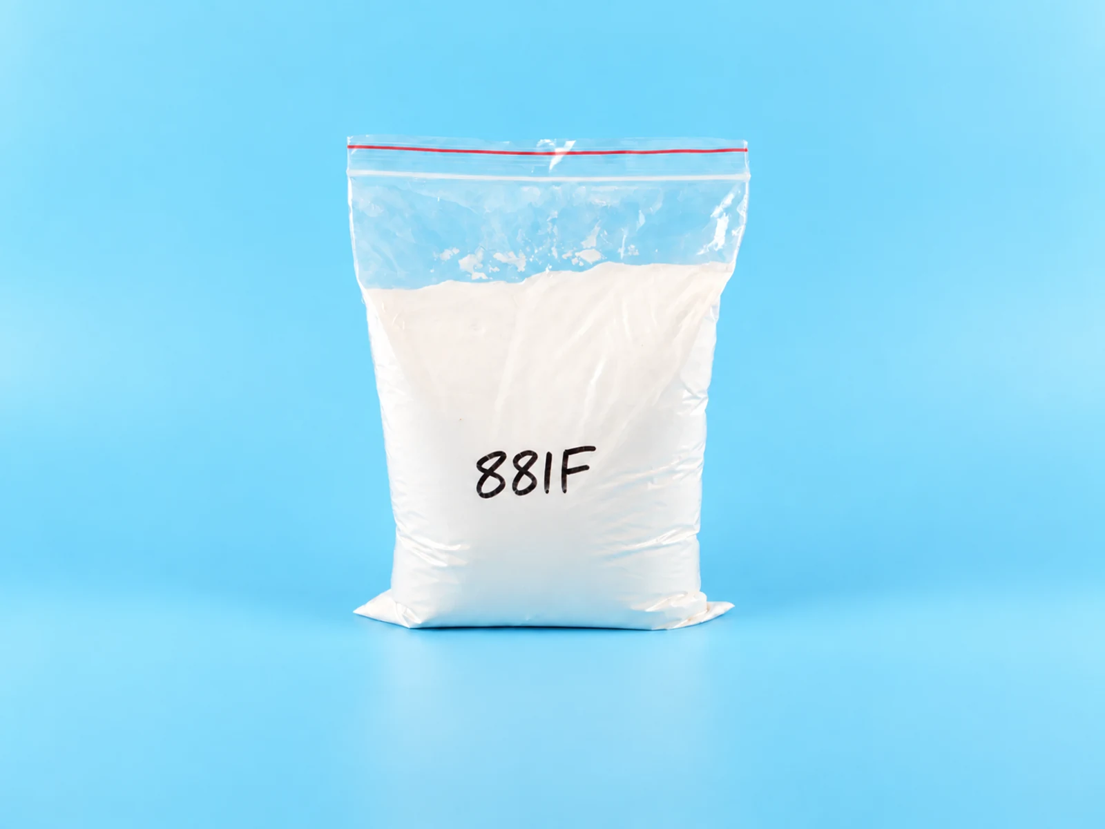White powder additive sample in a laboratory dish