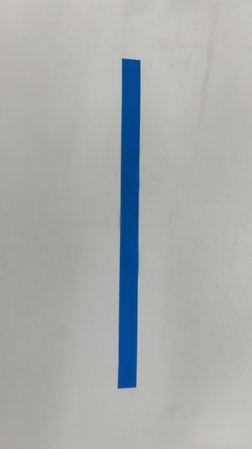 Straight blue tourniquet strip photographed on an inspection surface