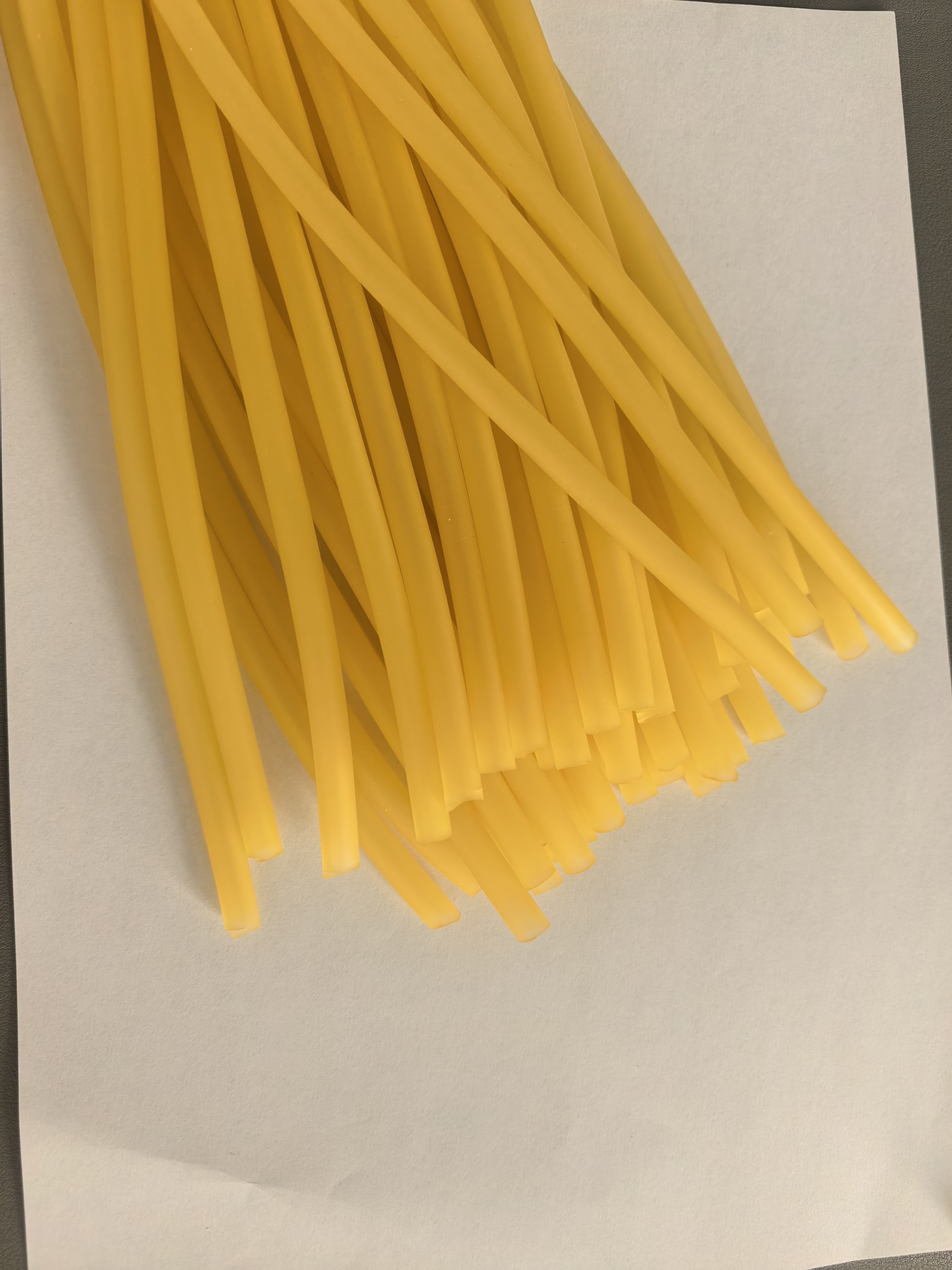 Yellow hemostatic tubing batch photographed on an inspection surface