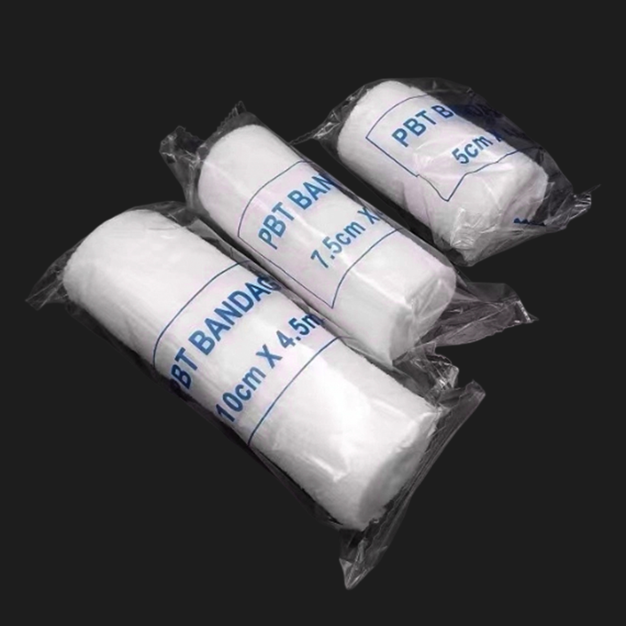 Three white PBT bandage rolls in individual clear packaging