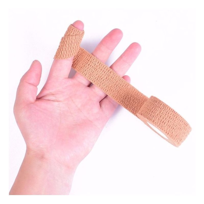 Beige cohesive bandage applied around a finger and hand