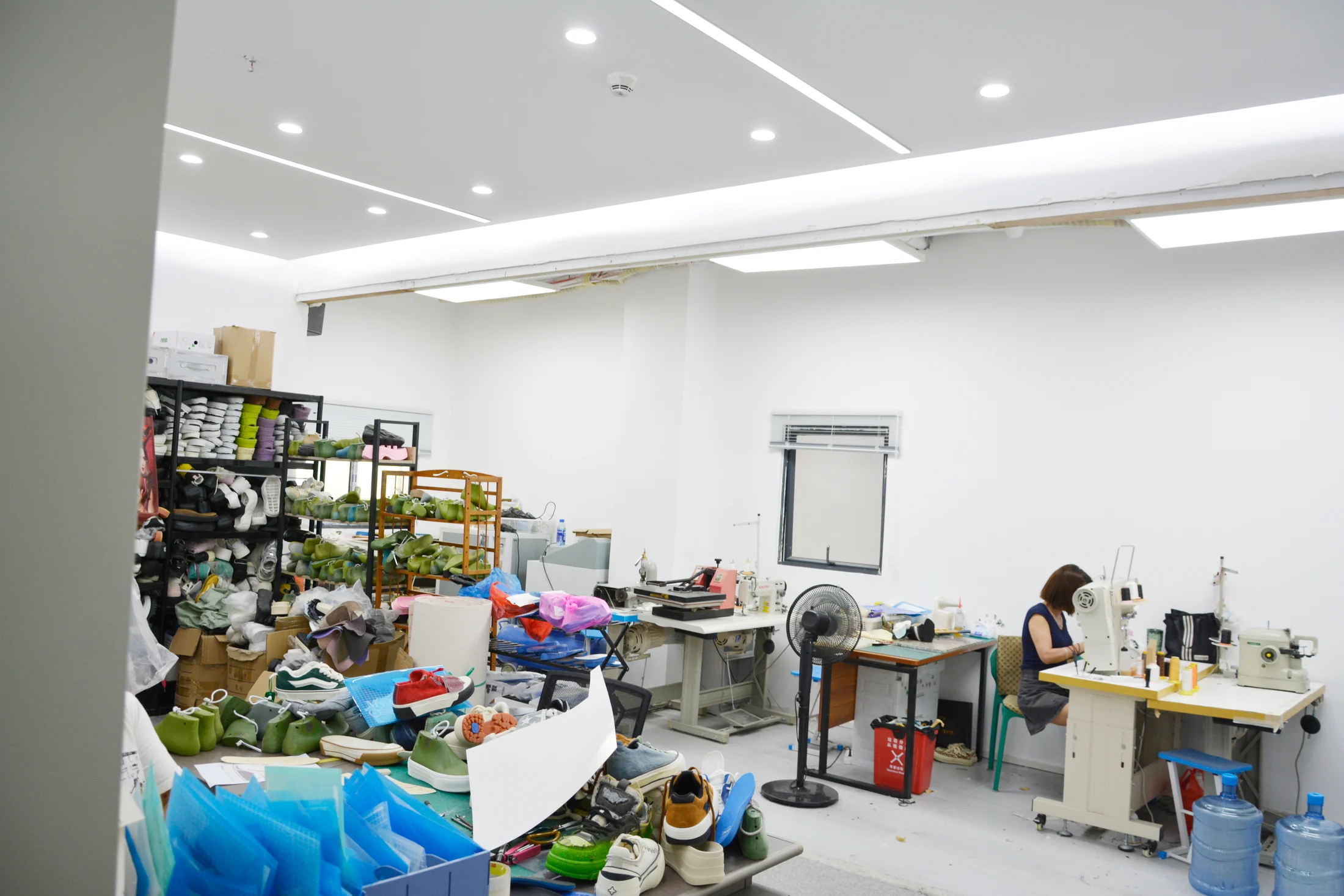 Sample-making workshop with sewing stations and shoe uppers