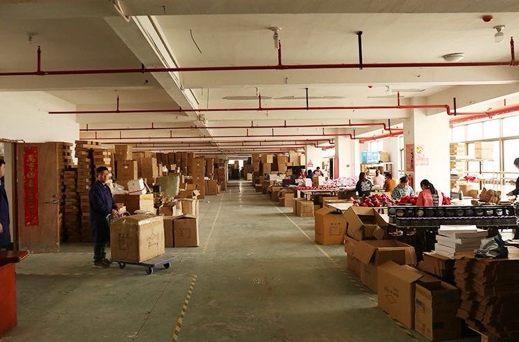 A workshop hall with cartons and team members working at tables