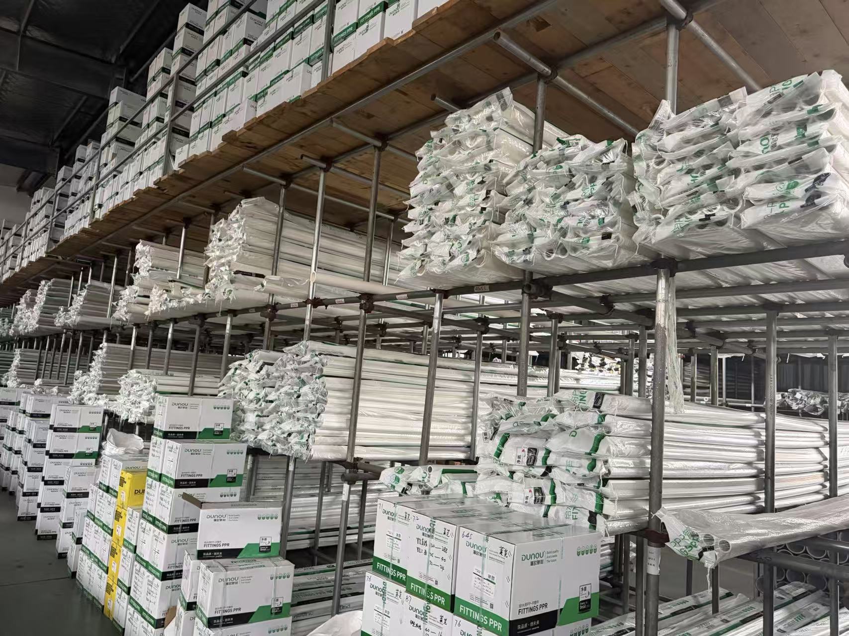 Shelves of packaged DIGAO pipe products in the supplied warehouse photograph
