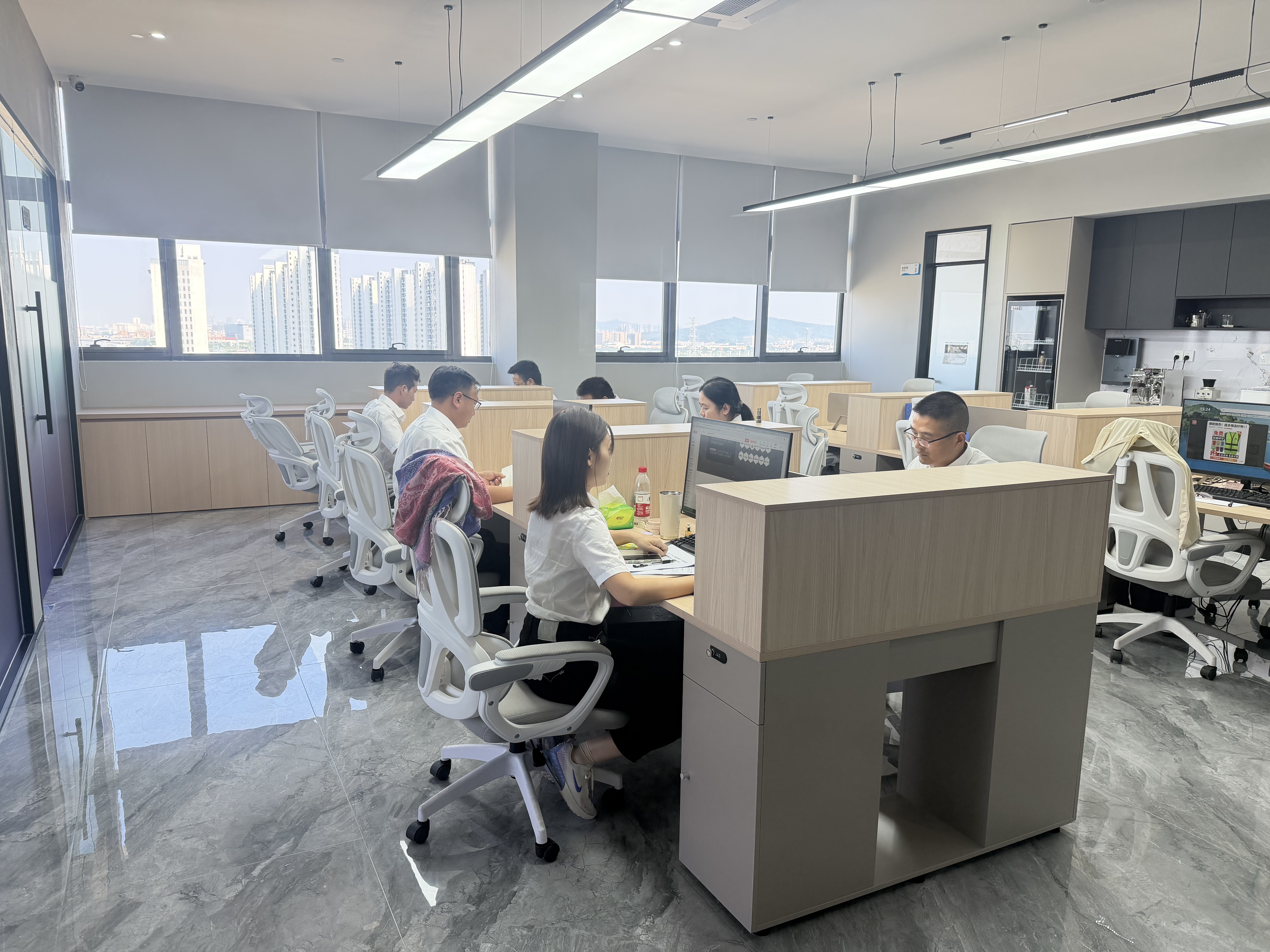 Dawei staff collaborating in the office work area.
