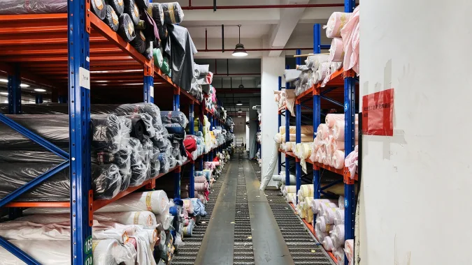 Fabric rolls and textile stock inside the company storage area