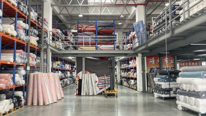 Fabric rolls and textile stock inside the company storage area