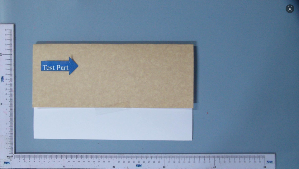 Laminated paper sample sheet laid flat on a wooden surface