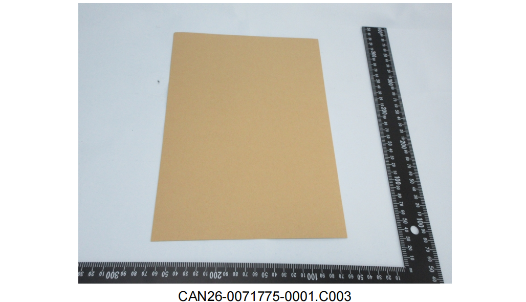 Red kraft paper sample sheet photographed beside a steel ruler