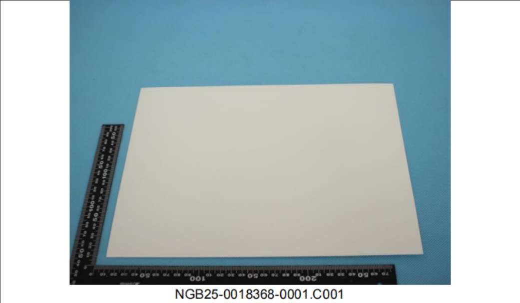 White kraft paper sample sheet photographed with rulers for scale
