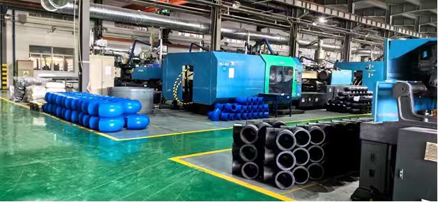 Plastic pipe sections beside the production equipment.