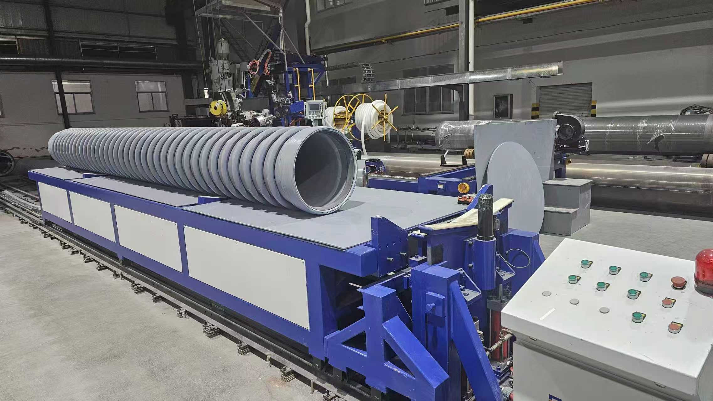 Wound pipe section on workshop handling equipment.