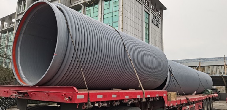 Large pipe section transported for a field project.