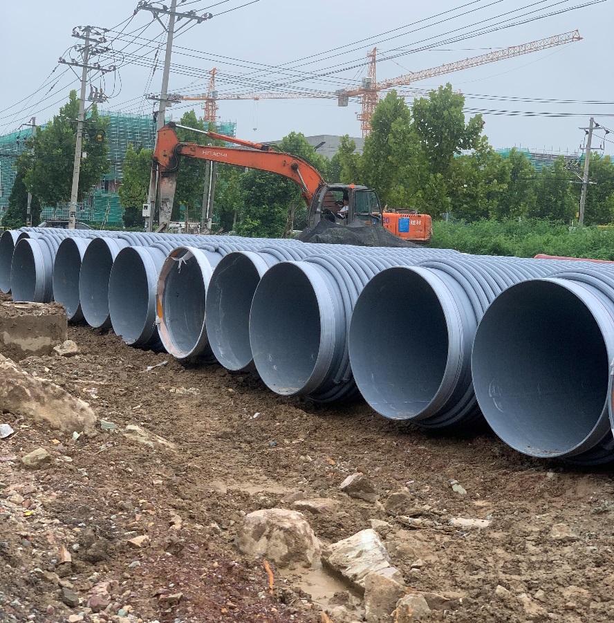 Pipe sections ready for installation at a project site.