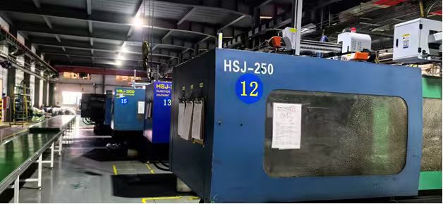 Blue injection molding machine on the factory floor.