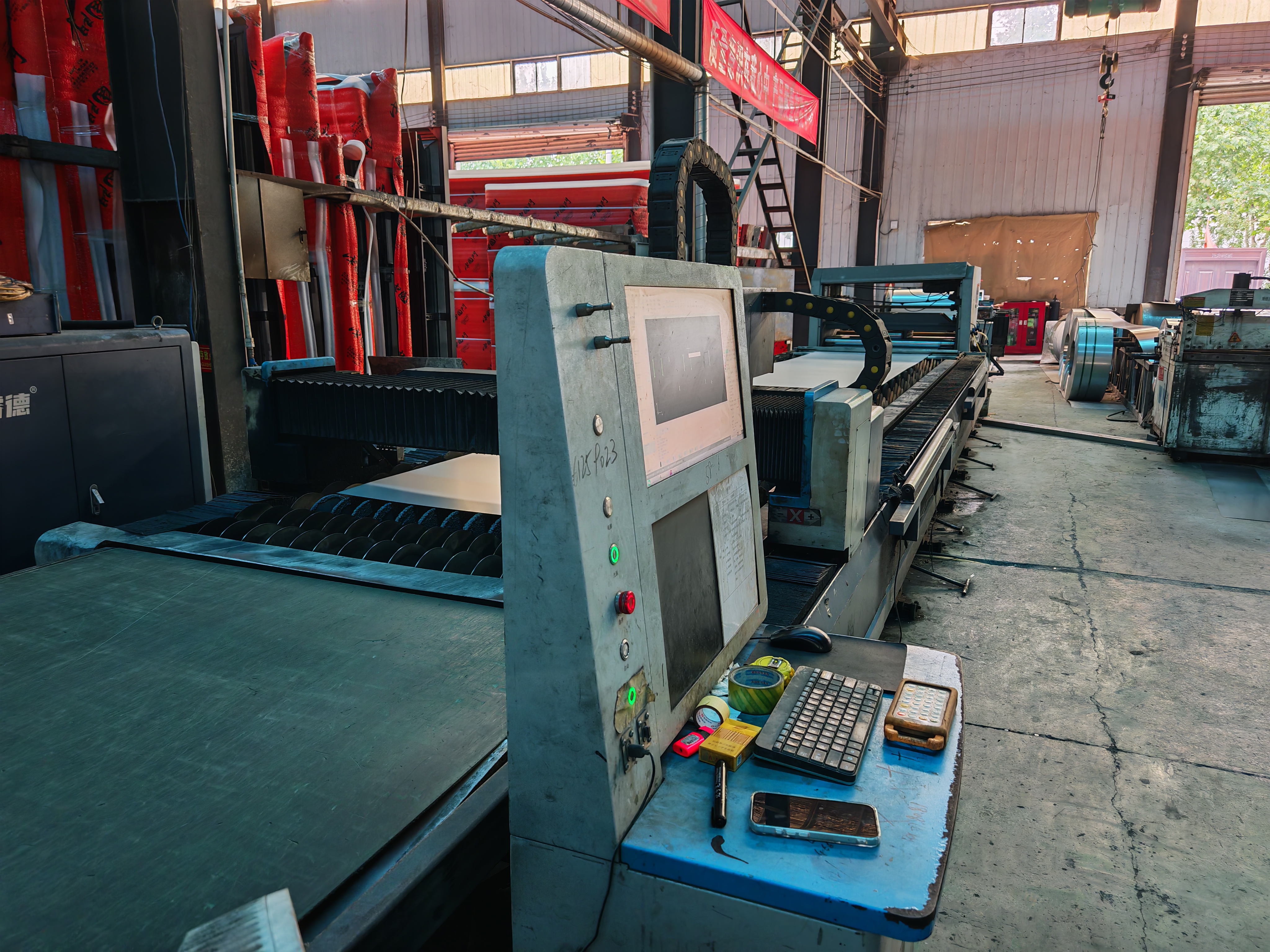 Technician operating precision cutting equipment on a door panel