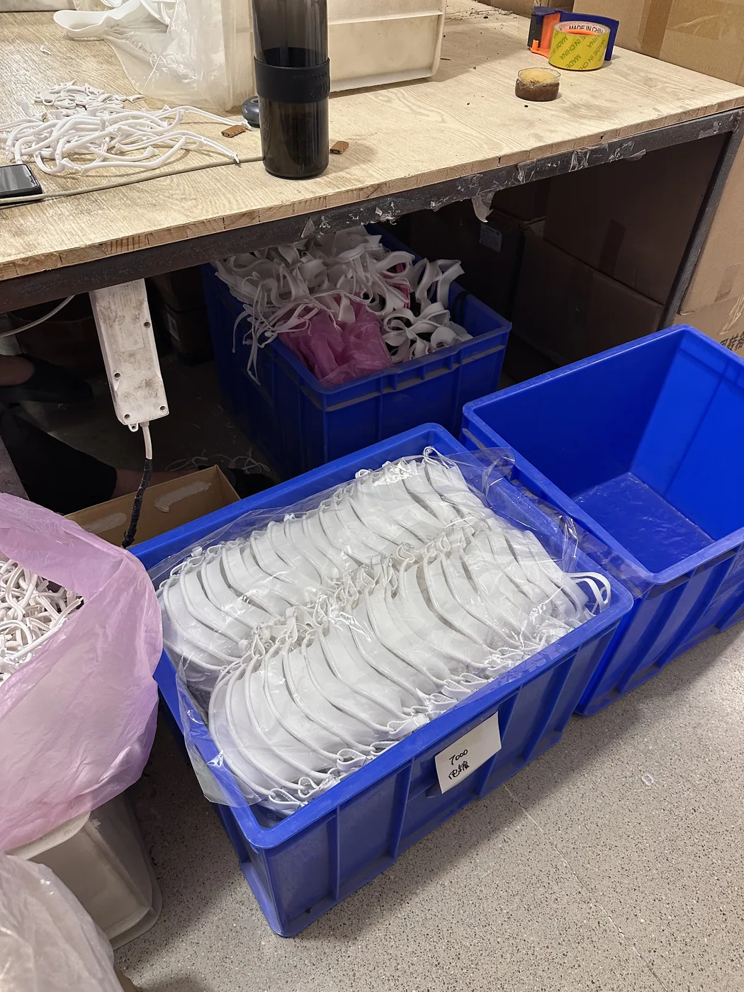 White product components arranged in blue bins
