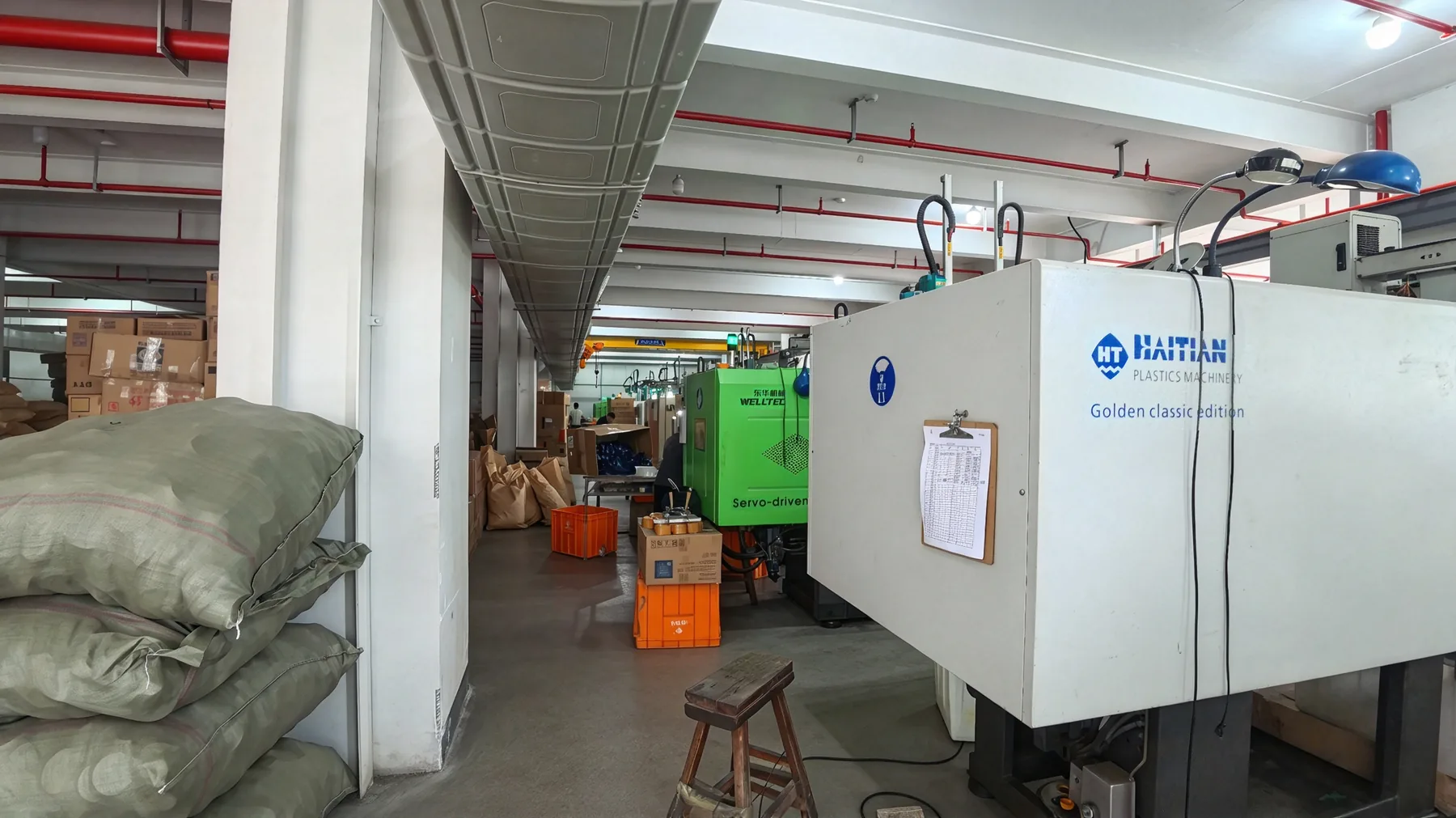 Machine beside bagged materials on a workshop floor
