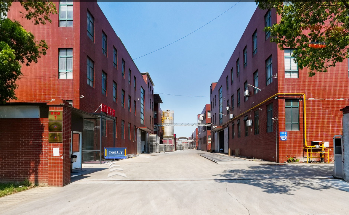 Driveway between red brick industrial buildings