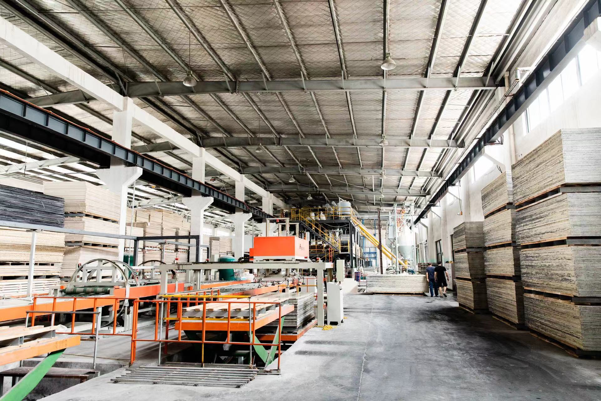 Board workshop with panel stacks and production equipment