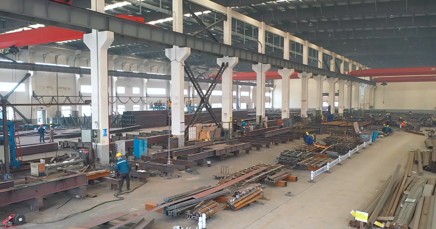 Structural steel beams and columns being fabricated inside the workshop