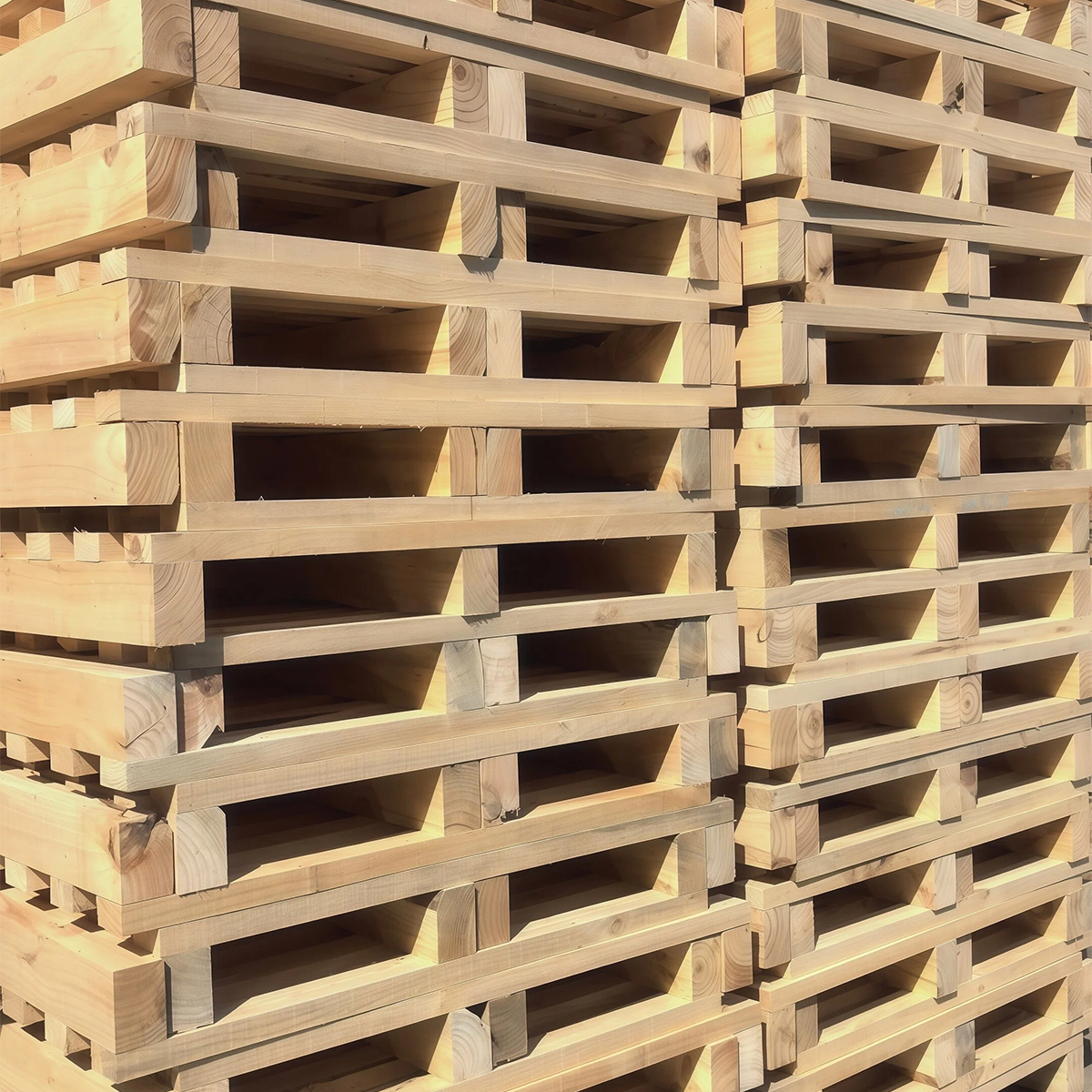Close-up of thick timber blocks on a heavy-duty wooden pallet stack